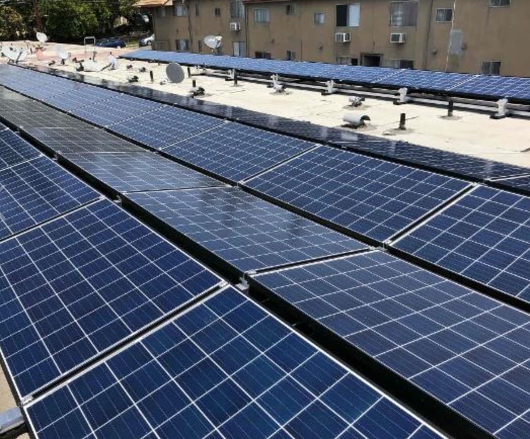 Rows of solar panels installed on a commercial rooftop