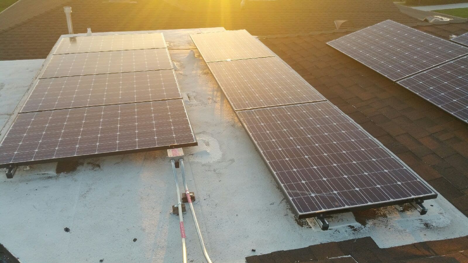 Solar panels on a flat roof at sunset