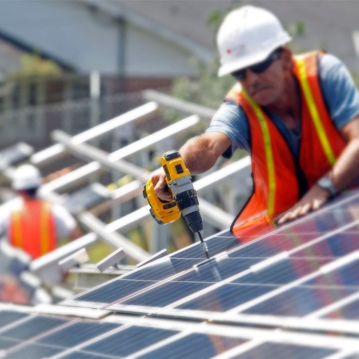 Installer securing a solar panel mount