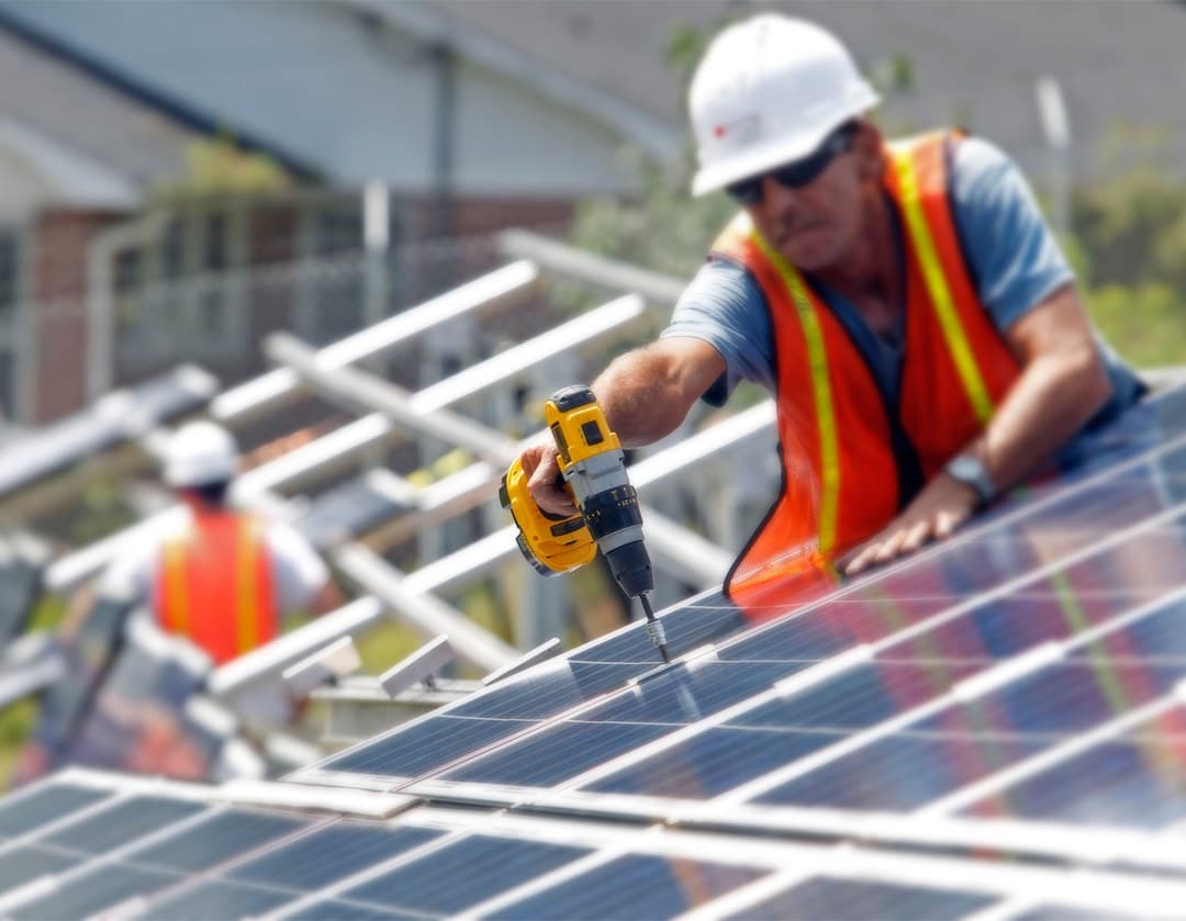 Installer securing a solar panel mount